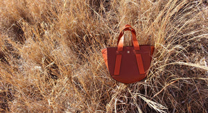 leather handbag in a field, made in greece