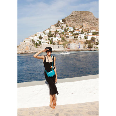 model wearing crossbody satchel bag and clutch, leather handbag handmade in Greece in pink
