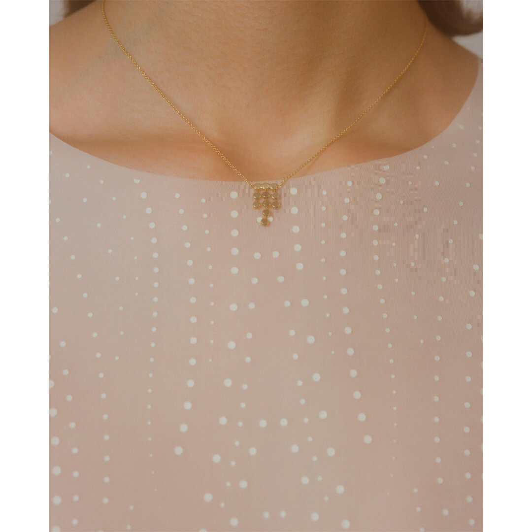 model wearing alegria gold pendant necklace, handmade in greece