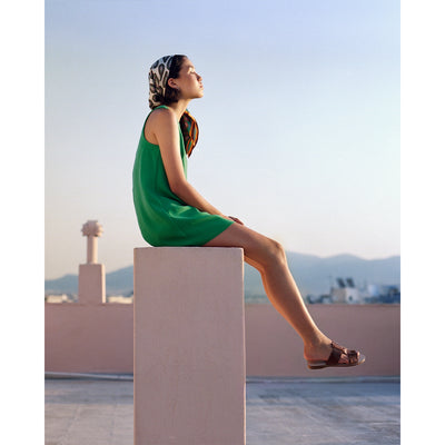 woman sitting on a rooftop in athens wearing greek leather sandals, #color_amber-snake