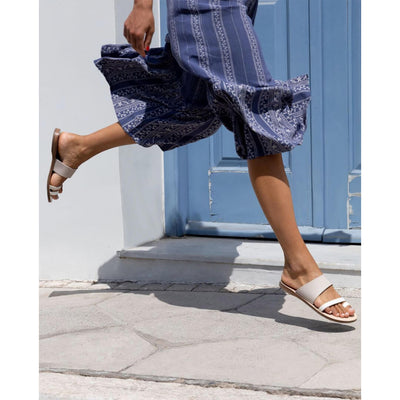 woman jumping in greek leather sandals, grey sandals, #color_greek-stone-grey