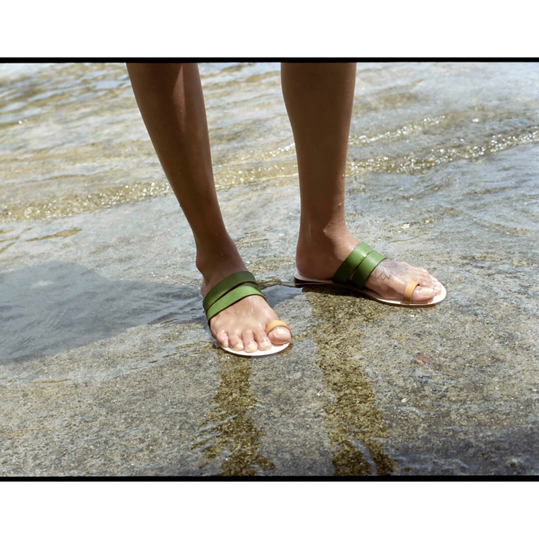 woman wearing greek leather sandals, handmade in greece, italian leather in olive green #color_moss-green